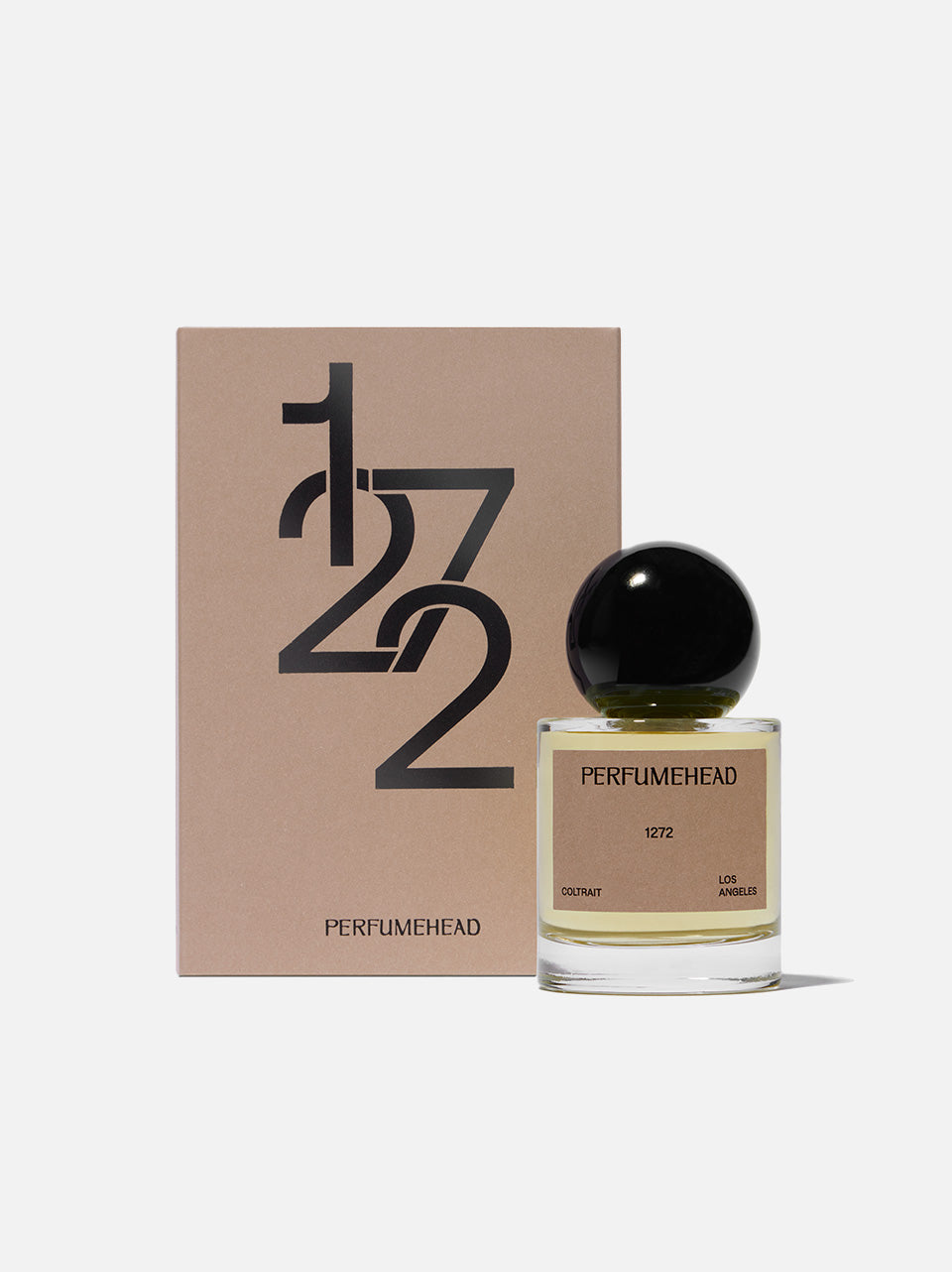 A bottle of Perfumehead 1272 Coltrait next to its brown cardboard packaging box, both featuring a minimalist black and beige design, set against a clean off-white background.
