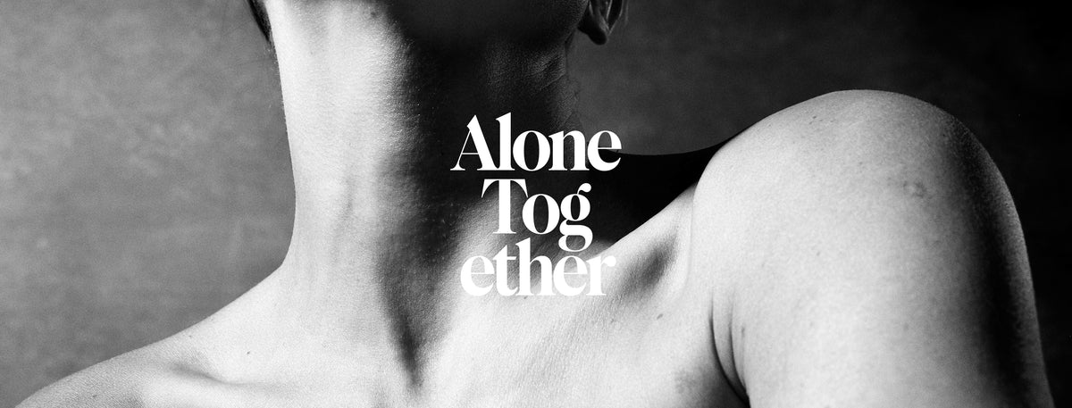 Black and white close-up of a person's neck and shoulder with the text 'Alone Together' overlaid in white serif lettering.