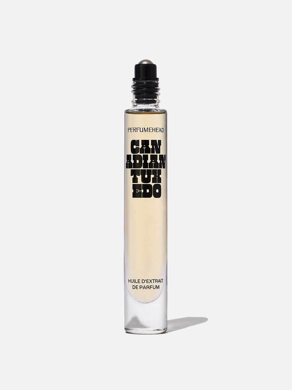 A clear glass rollerball perfume bottle with a black cap, containing a pale yellow liquid. The bottle features bold black text reading 'PERFUMEHEAD' and 'CANADIAN TUXEDO', set against a white background.